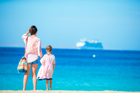 Little girl and young mother during beach vacationの写真素材