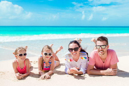 Family of four on the beach on caribbean vacation.の写真素材