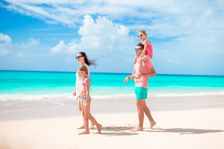 Happy beautiful family on a beach during summer vacationの写真素材