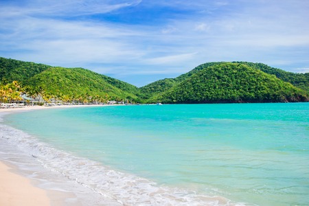 Idyllic tropical Carlisle bay beach with white sand, turquoise ocean water and blue sky at Antigua island in Caribbeanの写真素材