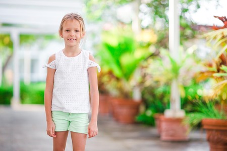Happy little girl outdoors at summerの写真素材