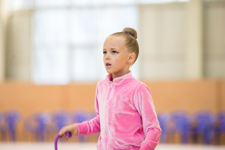 Adorable little girl athletes train in rhythmic gymnastics hallの写真素材