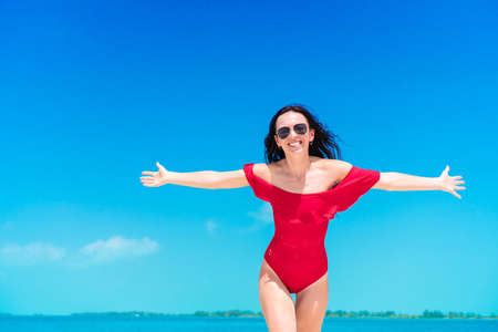 Young beautiful woman during tropical beach vacationの写真素材