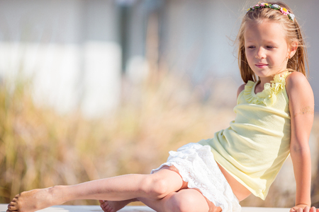 Portrait of adorable little girl in yoga outdoor on vacationの写真素材