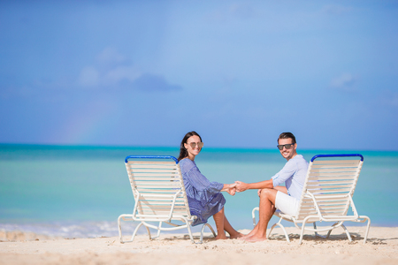 Couple relax on a tropical beach at Maldivesの写真素材