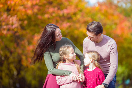 Portrait of happy family of four in autumn dayの写真素材