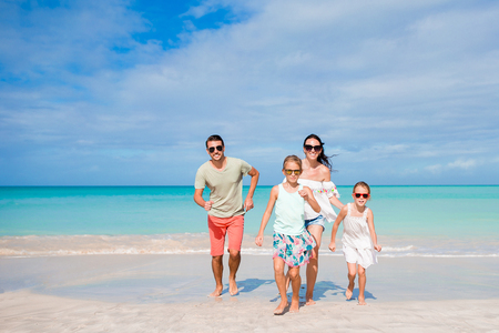 Young family on vacation on caribbean beachの写真素材