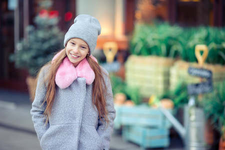 Adorable happy little girl outdoors in european city.の写真素材