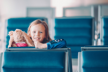 Little kid in airport waiting for boardingの写真素材