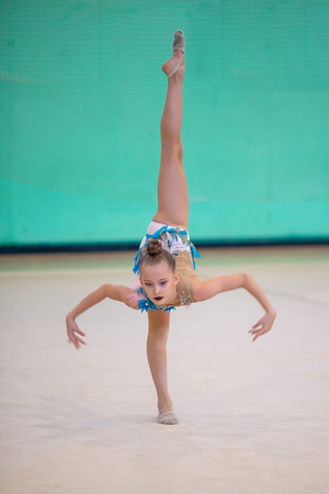 Little gymnast training on the carpet and ready for competitionsの写真素材