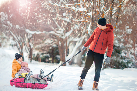 Family of dad and kids vacation on Christmas eve outdoorsの写真素材