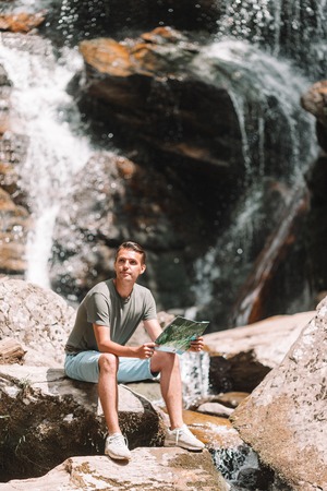 Man enjoying view of waterfall in gungle