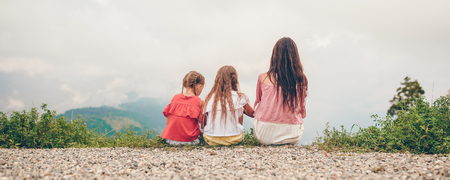 Beautiful happy family in mountains with amazing landscape of backgroundの写真素材