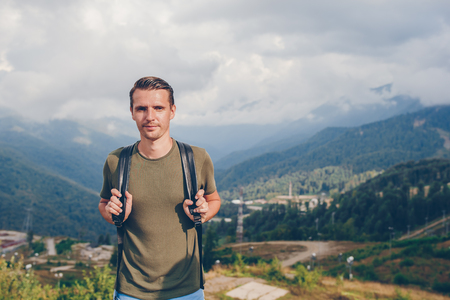 Tourist man in mountains in the background of fogの写真素材