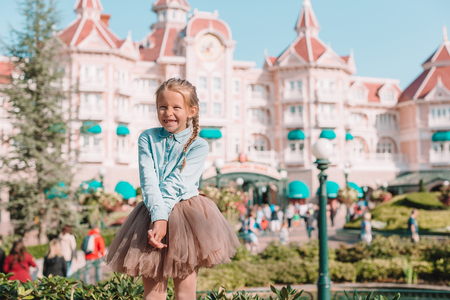 Little adorable girl in Cinderella dress at fairy-tale Disneyland parkのeditorial素材