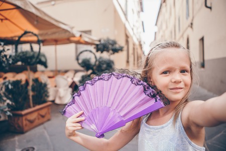 Adorable fashion little girl outdoors in European cityの写真素材