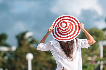 Young sexy woman enjoying rest on the edge of outdoor swimming poolの写真素材