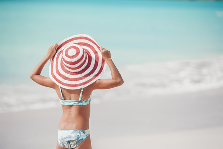 Cute little girl in hat at beach during caribbean vacationの写真素材