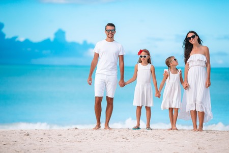 Happy beautiful family with kids on the beach