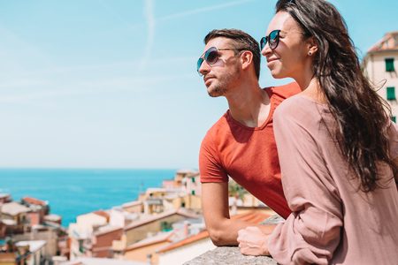 Tourists looking at scenic view of Riomaggiore, Cinque Terre, Liguria, Italyの写真素材