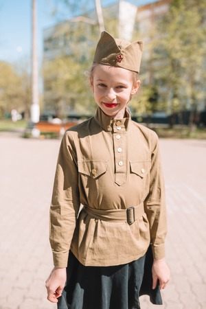 Little girl in military uniform on holiday day of victoryの写真素材