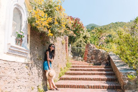 Smiling happy girl having fun during holidays in Cinque Terreの写真素材