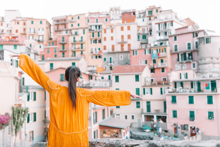 Tourist looking at scenic view of Manarola, Cinque Terre, Liguria, Italyの写真素材