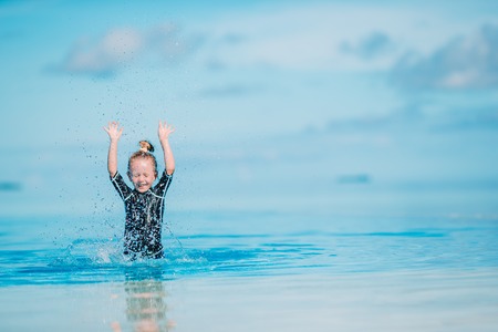 Portrait of adorable little girl at beach during summer vacationの写真素材