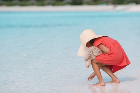 Adorable little girl in hat at beach during summer vacationの写真素材
