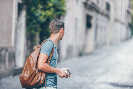 Boy caucasian with smartphone walking in street at Europeの写真素材