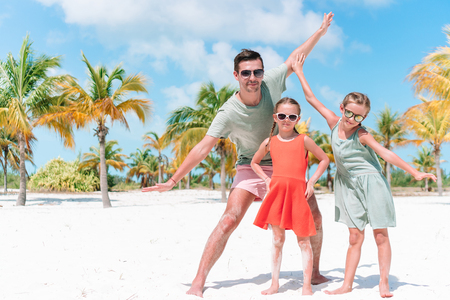 Family walking on white tropical beach on caribbean islandの写真素材