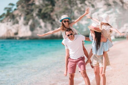 Happy beautiful family with kids on the beachの写真素材