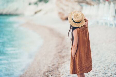Young beautiful woman on white tropical beach.