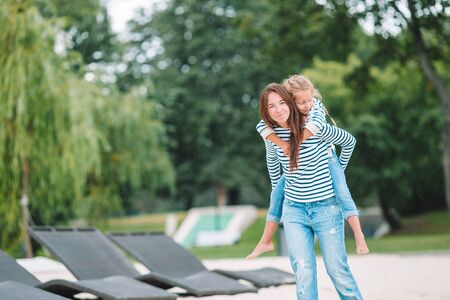 Happy mom and adorable little girl enjoying summer vacationの写真素材