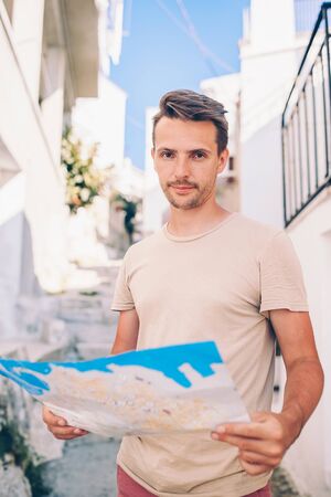 Man tourist with a city map outdoors