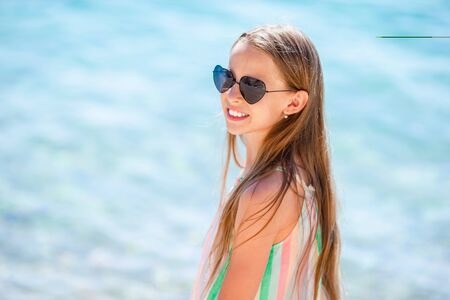 Cute little girl at beach during summer vacationの写真素材