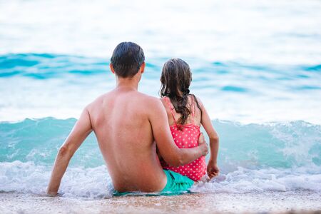 Father and his daughter enjoy beach vacationの写真素材