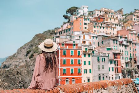 Young woman with great view at old village Riomaggiore, Cinque Terre, Liguriaの写真素材