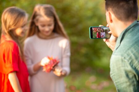 Little adorable girls outdoors at warm sunny autumn dayの写真素材