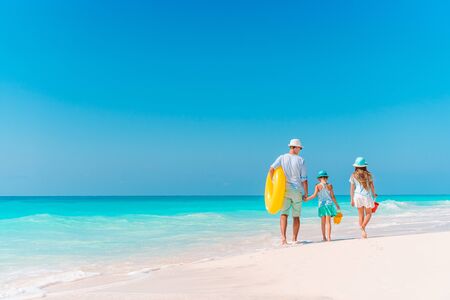 Father with kids on the beach going to swim. Family vacationの写真素材