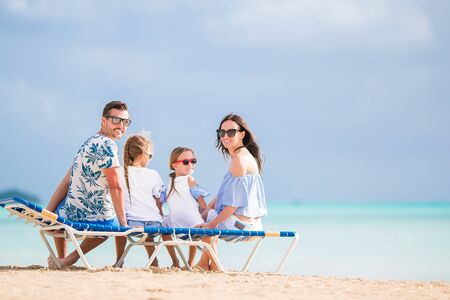 Happy family on the beach during summer vacationの写真素材