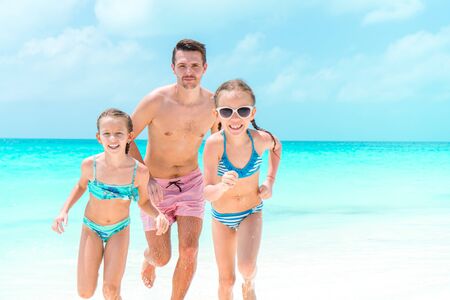 Father and kids enjoying beach summer vacationの写真素材