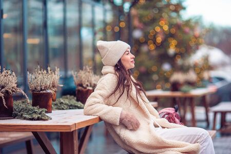 Happy girl near fir-tree branch in snow for new year.の写真素材