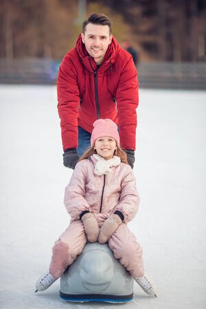 Family winter sport. Father and daughter on winter dayの写真素材