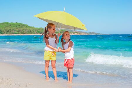 Kids have a lot of fun at tropical beach playing togetherの写真素材