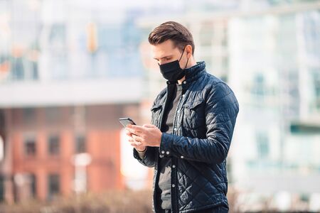 Man wearing a mask on a background of a modern building,の写真素材
