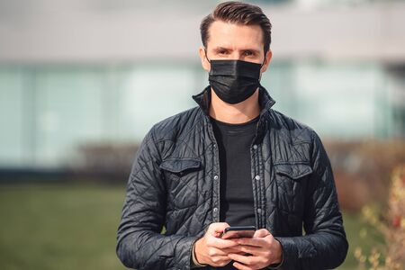 Man wearing a mask on a background of a modern building,の写真素材