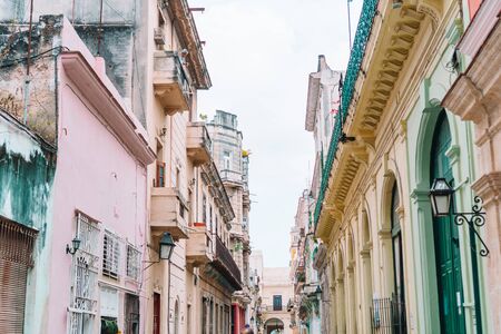 HAVANA, CUBA - APRIL 14, 2017: Authentic view of a street of Old Havana with old buildings and carsの写真素材