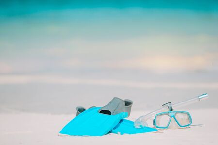 Snorkeling equipment mask, snorkel and fins on white sandy beachの写真素材