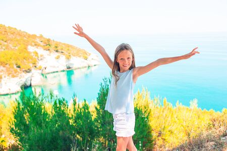 Little girl on vacation travel background beautiful landscapeの写真素材